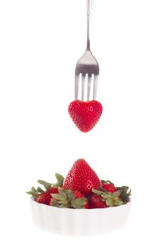 strawberry with fork, isolated on white