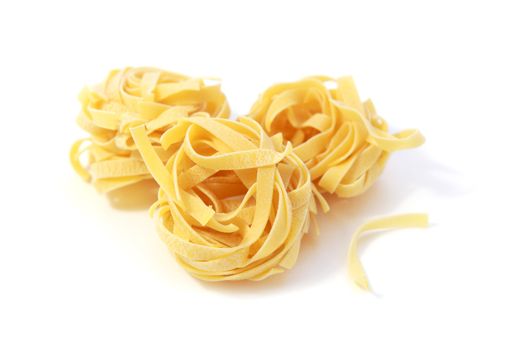 raw dry Italian pasta - noodles on white background