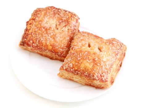 domestic puff cake with jam on plate on white background