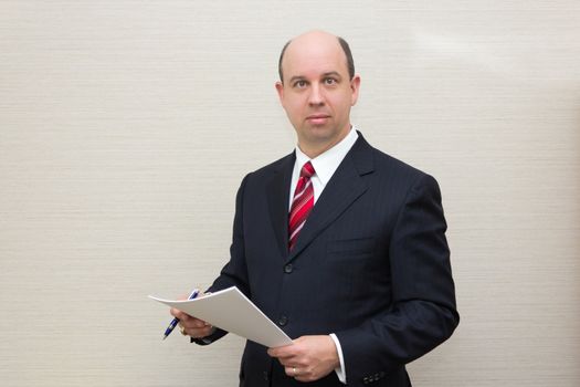 Business man holding a document.