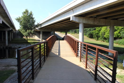 Two highway bridges with old antique bridge underneath.