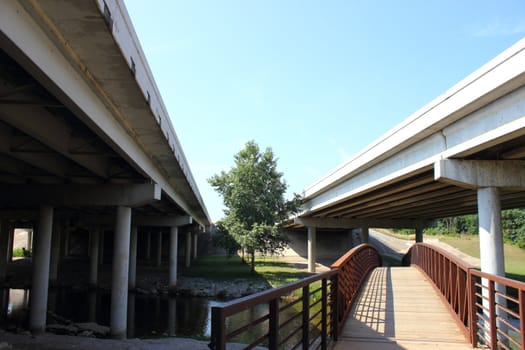 Two highway bridges with old antique bridge underneath.