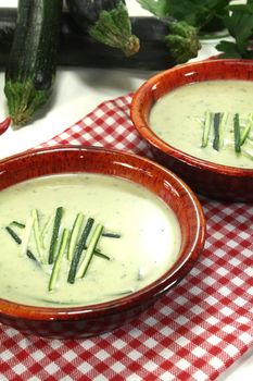 fresh creamy zucchini soup in bowls on a napkin
