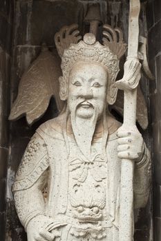 one of the eight statues of gods, according to chinese beliefs, found in a chinese temple.