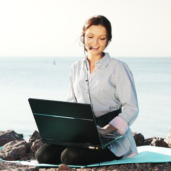 woman work on laptop sea on background