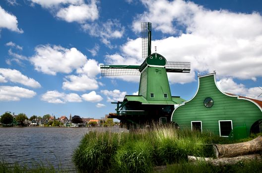 green windmill over blue sky in Zaanse Schans