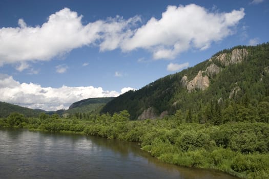 Summer. A river landscape with clouds.