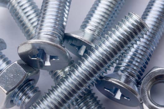 The large bolts and screws on a white background.