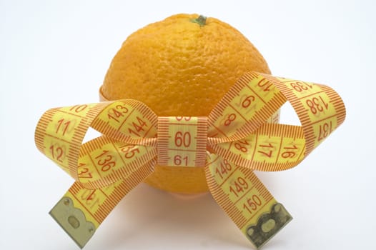 Orange  with measuring tape. White background.