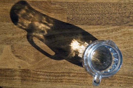 Decanter with water on a wooden floor.