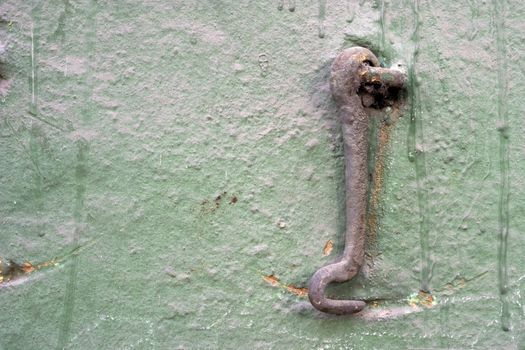 Old wall with a metal hook.