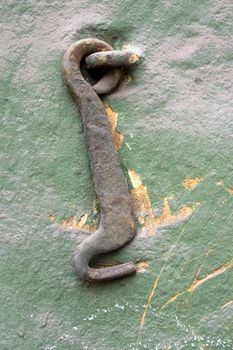 Old wall with a metal hook.