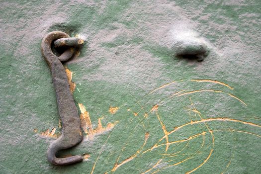Old wall with a metal hook.
