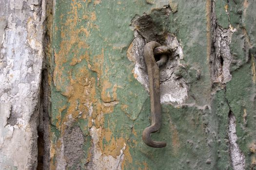 Old wall with a metal hook.