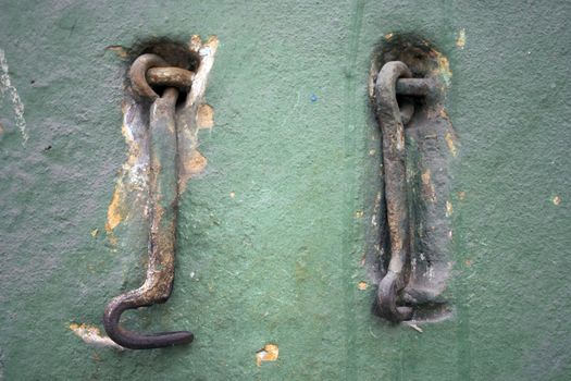 Two old metal hooks.