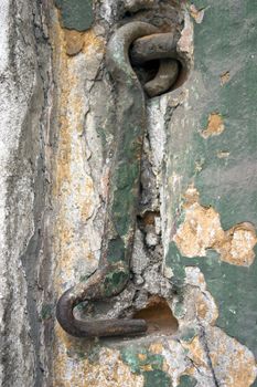 Old wall with a metal hook.