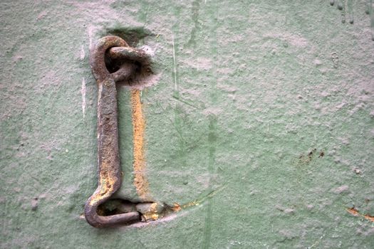 Old wall with a metal hook.