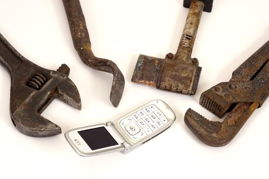 Old  tools and modern telephone on a white background.
