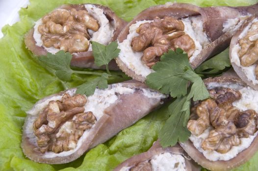 Tongue stuffed with a nut on a white plate.