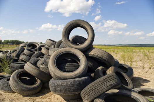 A lot of Wheel Tires dumped in a landfill.