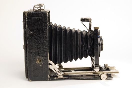 The old photographic chamber with a lens of furs on a white background.
