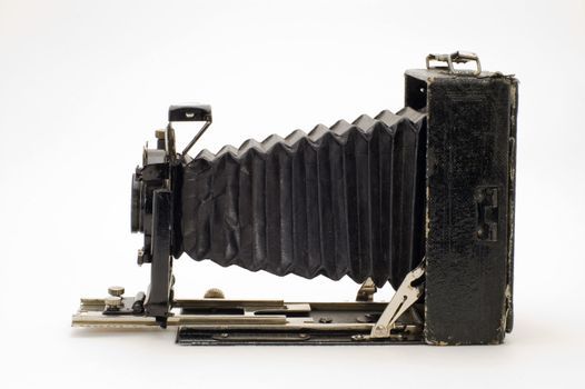 The old photographic chamber with a lens of furs on a white background.