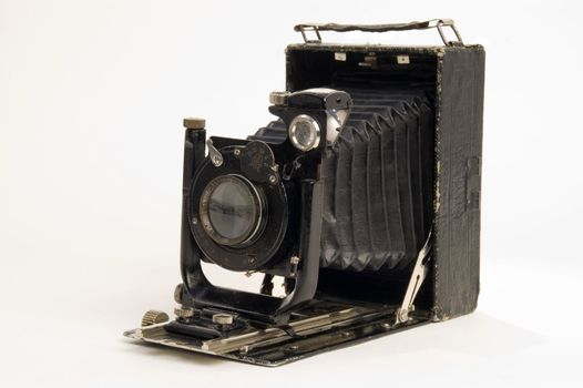 The old photographic chamber with a lens of furs on a white background.