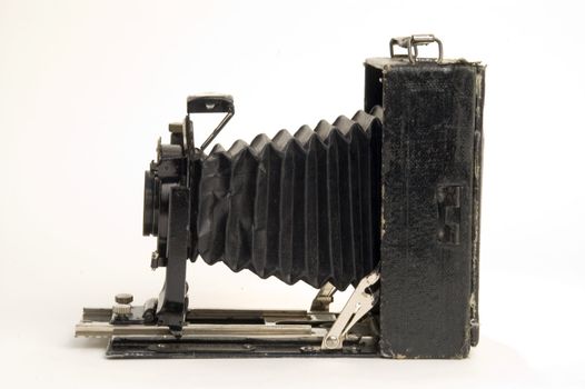 The old photographic chamber with a lens of furs on a white background.