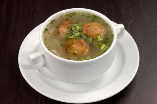 Vegetable soup on a white plate.