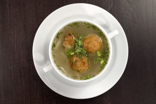 Vegetable soup on a white plate.