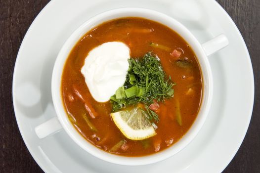 Vegetable soup on a white plate.