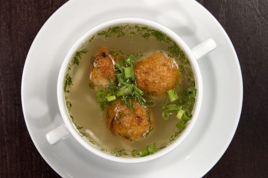Vegetable soup on a white plate.