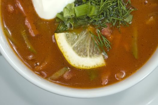 Vegetable soup on a white plate.