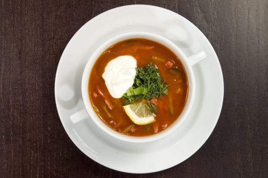 Vegetable soup on a white plate.
