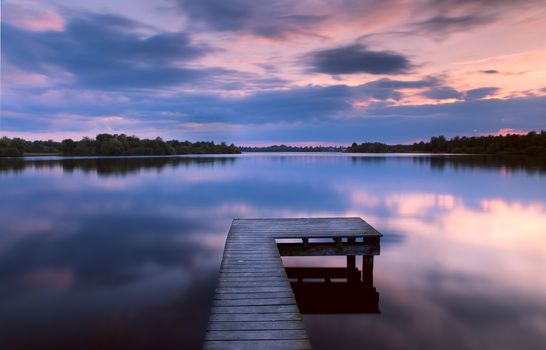 view from pier on lake during sunset