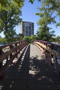 Pedestrian crossing a bridge in a downtown river park, Reno NV.