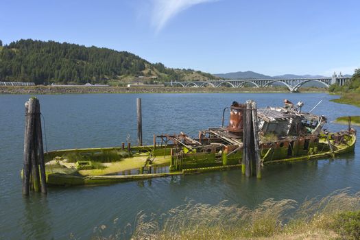 A wreck and abandoned fishing vessel in a bayou in Gold Beach OR.