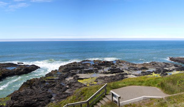 Rocky lava shoreline panorama at Cape Perpetua Oregon coast.