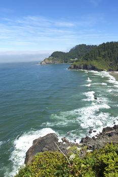 Haceta lighthouse under restoration, and the Oregon coastline.