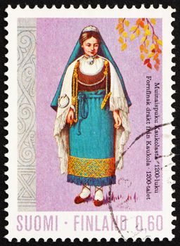 FINLAND - CIRCA 1972: a stamp printed in the Finland shows Woman from Kaukola, 13th Century, Regional Costume, circa 1972
