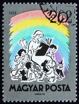HUNGARY - CIRCA 1959: a stamp printed in the Hungary shows Teacher Reading Fairy Tales, circa 1959