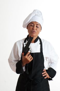 A asian woman as restaurant chef with a gun in the hand