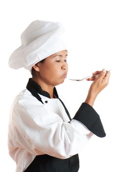 A asian woman as restaurant chef tasting something with a spoon in the hand on white background