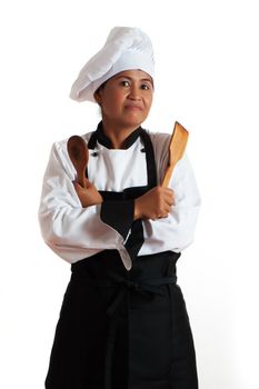A asian woman as restaurant chef with wooden kitchen tools in the hand