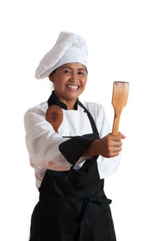 Smiling asian woman as restaurant chef with wooden kitchen tools in the hand