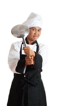 A asian woman as restaurant chef with a kitchen sieve in the hand
