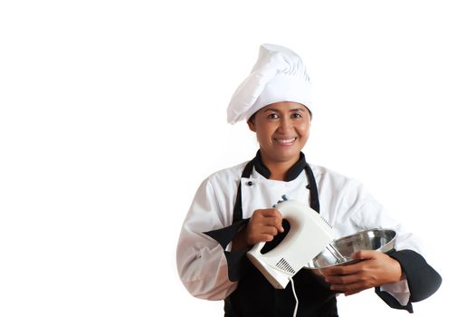 Smiling asian woman as restaurant chef mixing something with a mixer in a bowl