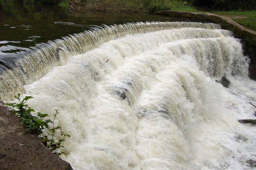 Weir on River Wye Monsal Dale in full force