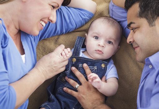 Mixed Race Family Playing Face Up on the Blanket.