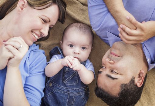 Mixed Race Family Playing Face Up on the Blanket.